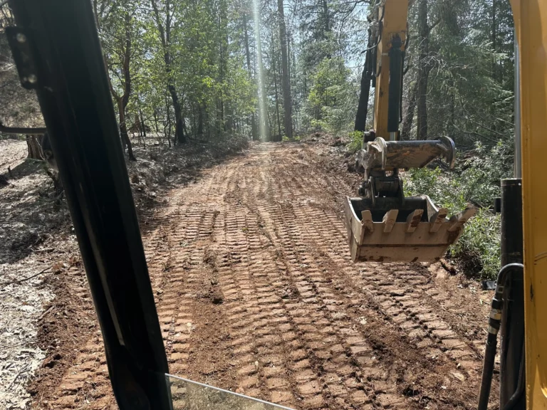 Excavator and cleared land illustrating demolition and excavation services in Sacramento.