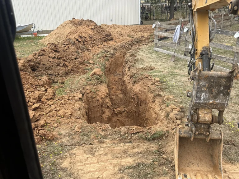 Excavation project in Sacramento with heavy machinery and a trench.