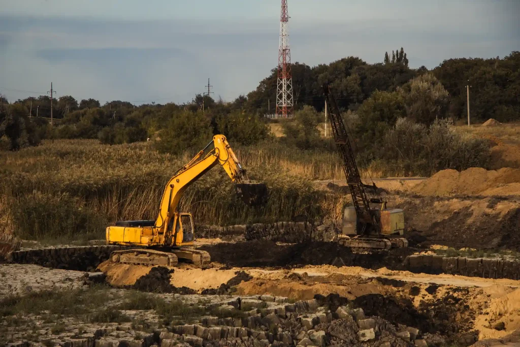 Excavator clearing overgrown vacant land for land clearing in North Highlands, CA
