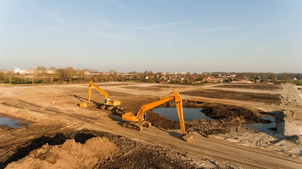 Two excavators working a large excavation site for a demolition contractor serving Granite Bay, CA