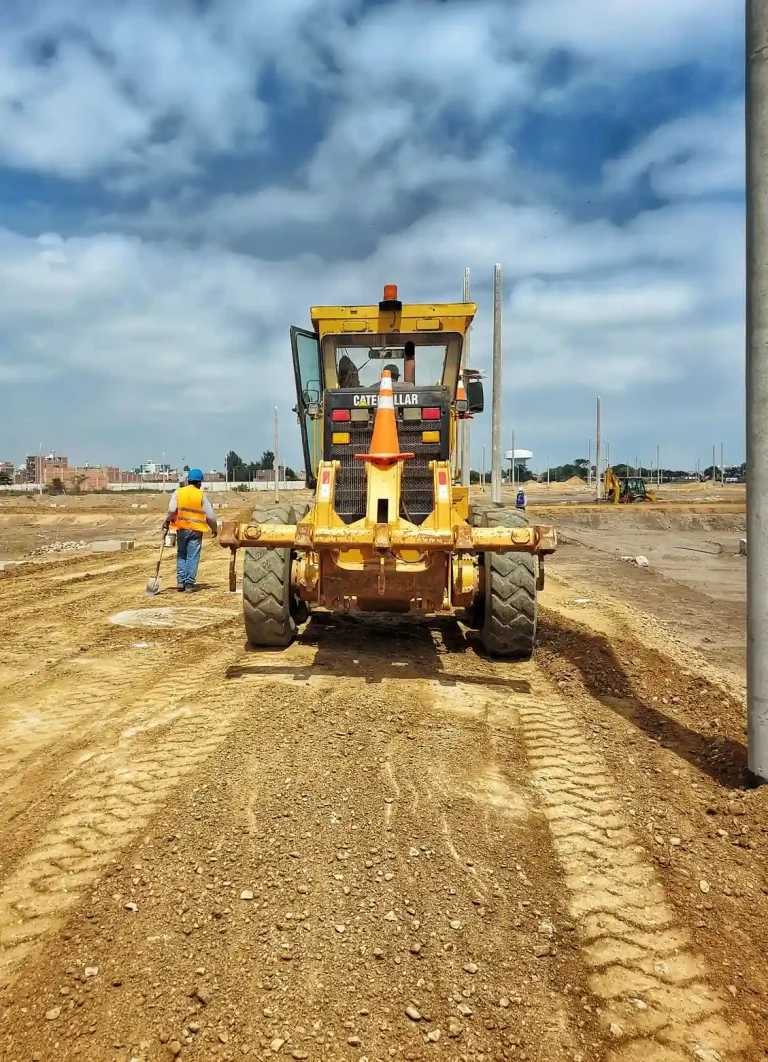 Motor grader and a worker on a road project in the North Highlands, CA service area